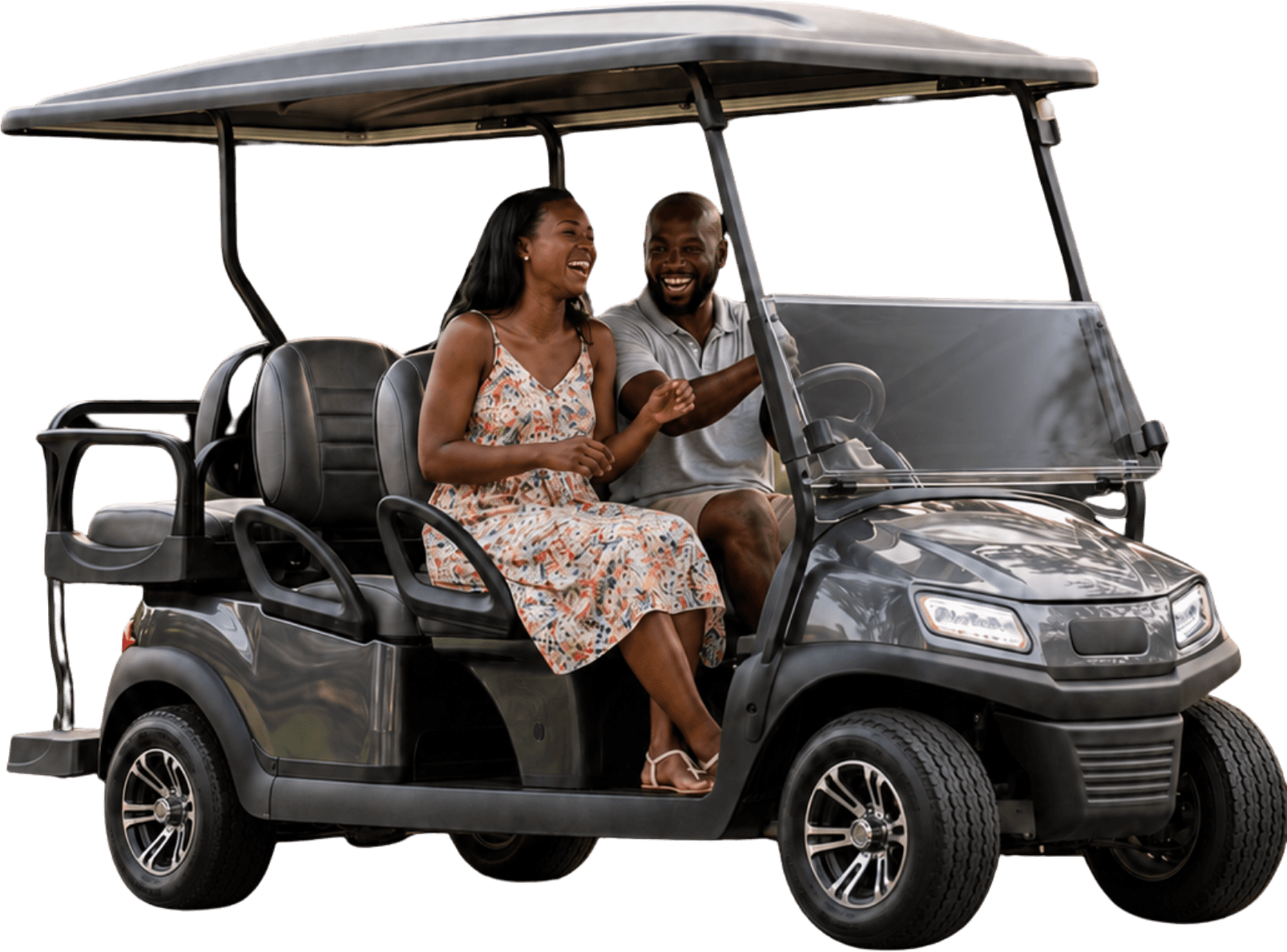 A couple laughing together as they ride in their golf cart
